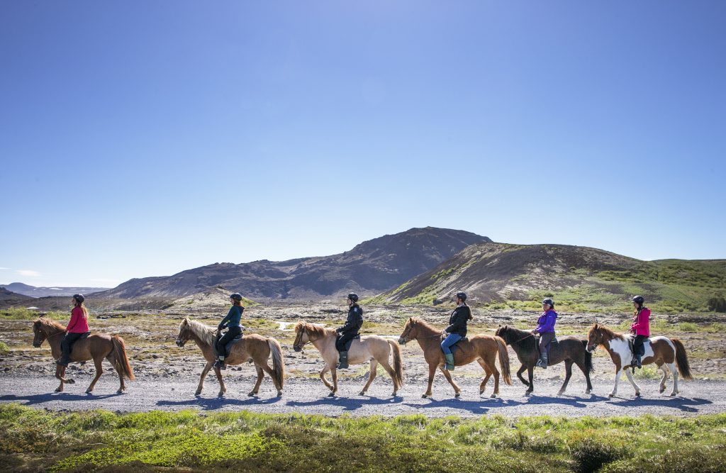 women riding horses on mountains