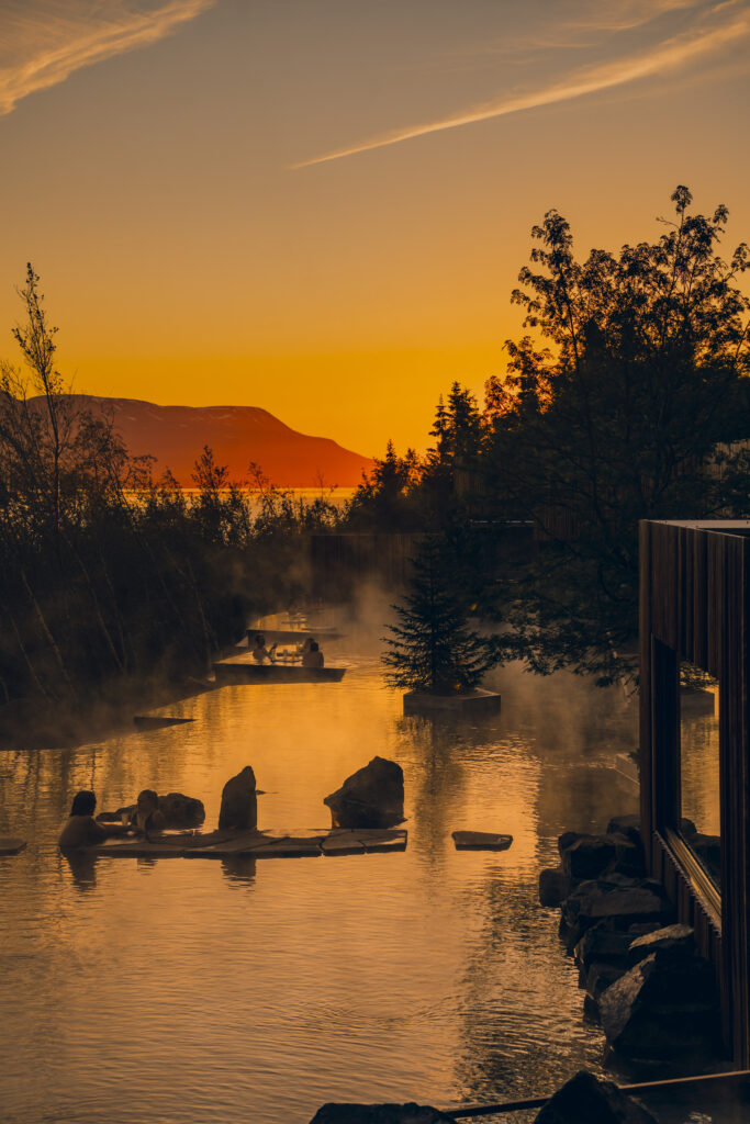 people in a hot spring during sunset