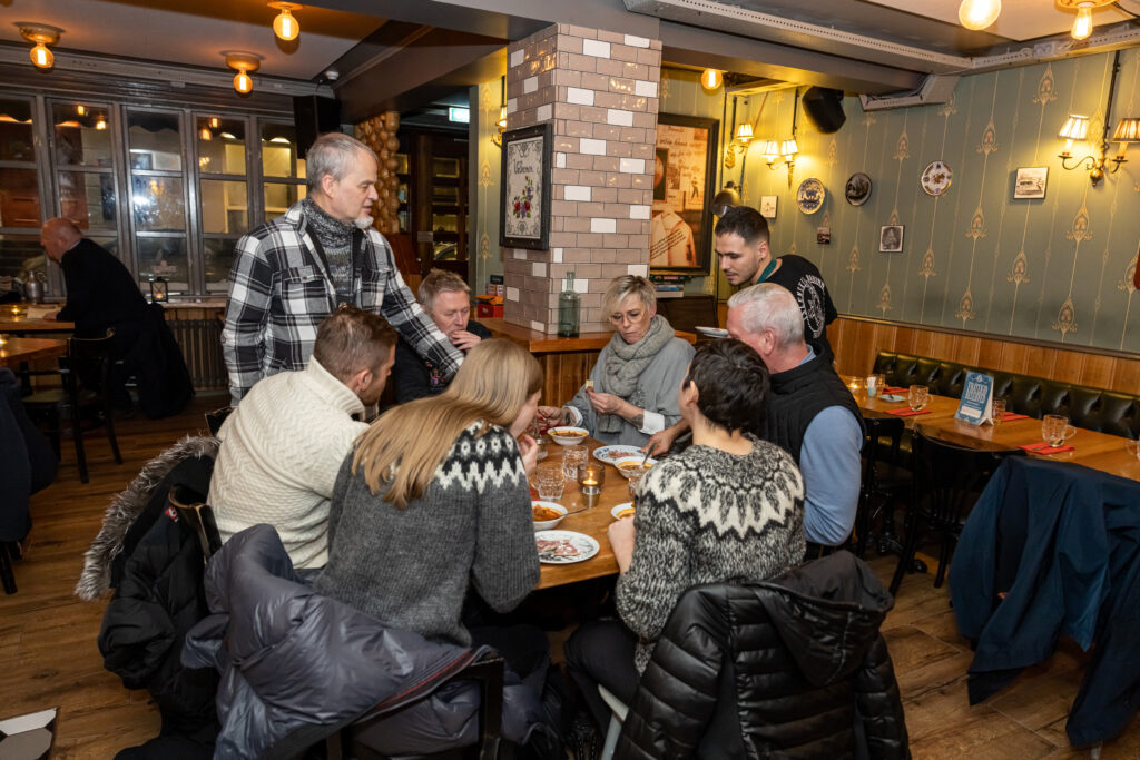 a group of people eating in a restaurant